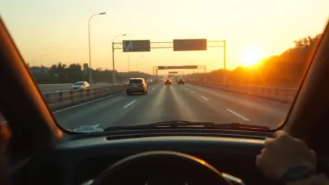 Fuel-efficient compact sedan driving a city highway during a morning commute